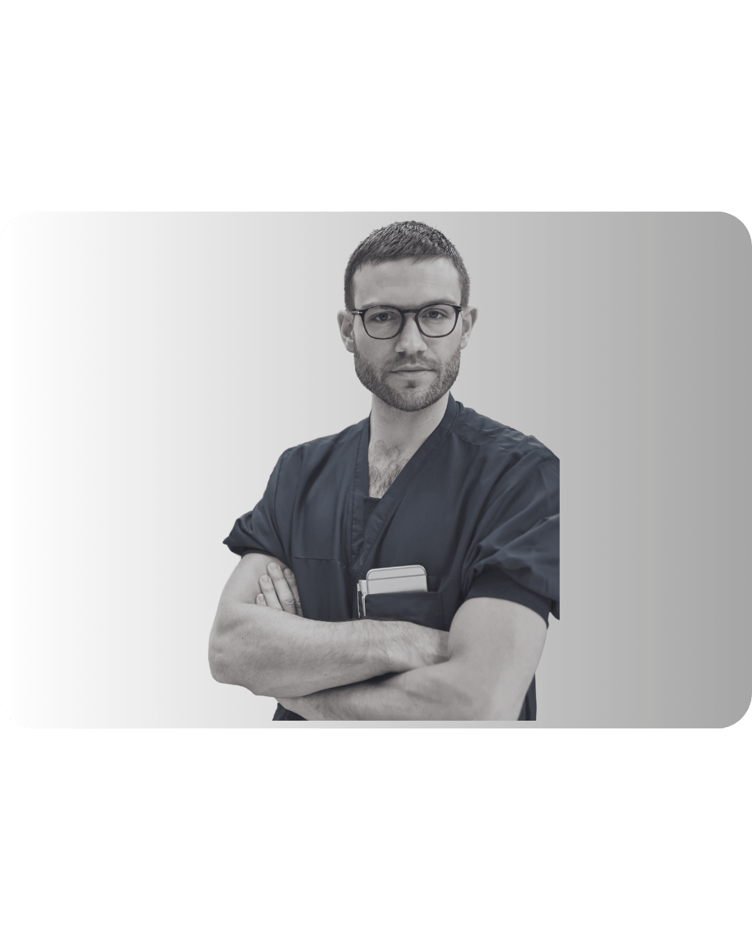 A man in dark scrubs stands confidently, wearing glasses, with arms crossed.
