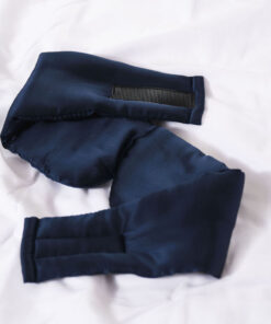 Navy blue fabric sleeves with an elastic band, resting on a white surface.