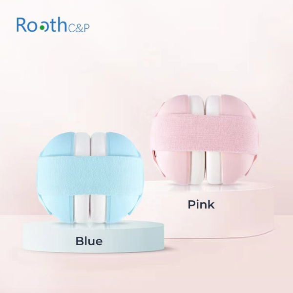 Two padded knee supports in pink and blue on a pale surface.