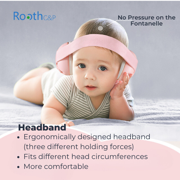 Baby lying on bed with baby earmuffs