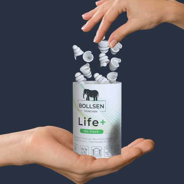 Hands releasing white earplugs from a grey and green cylindrical package.