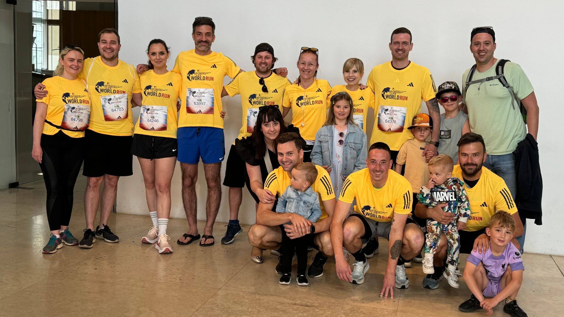 Group of runners in yellow shirts, children, with the founder of BOLLSEN Earplugs Hearing Protection.
