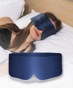 Woman asleep wearing the navy BOLLSEN Deep Sleep Mask, with the silk mask shown in the foreground